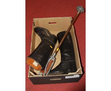 A pair of vintage leather riding boots together with a shooting stick