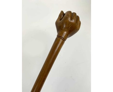 A carved hard wood walking stick, the handle in the form of a hand holding a ball, 87cmIn good condition, free from breaks or