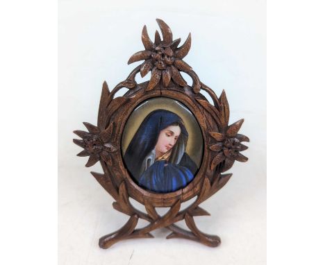 *A 19th century portrait miniature of a lady, painted on porcelain, 5.5x4.5cm, housed in a carved frameTiny nibbles to the ex