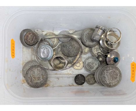 A collection of mixed coinage to include George V half crowns, silver ear clip, thimble, bangle, etc