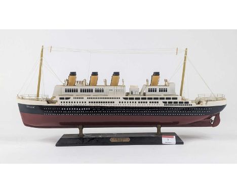A painted wooden model of The Titanic on stand, length 49cm