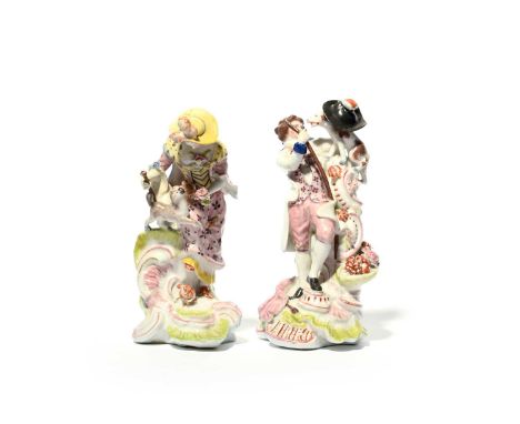 A pair of Vauxhall figures of a gallant and his companion, c.1756-60, each raised on tall scrolled bases picked out in green 