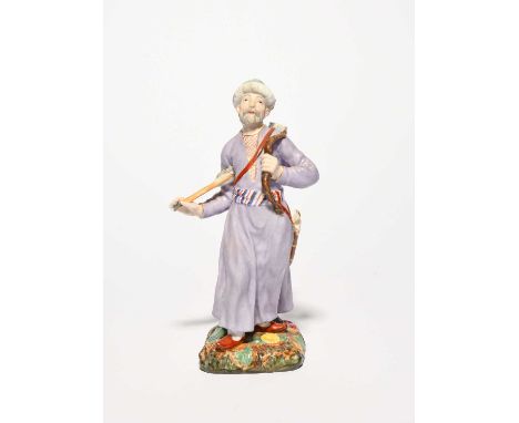 A Russian porcelain figure of an Ottoman archer, Popov Manufactory, 19th century, wearing a long lilac robe tied with a strip