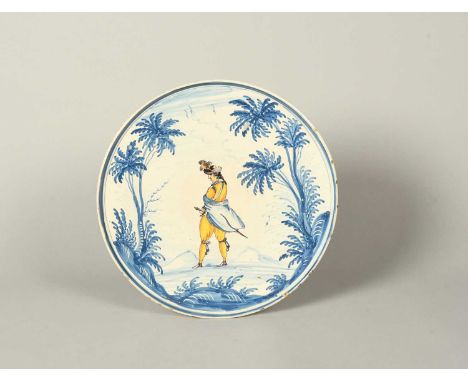 A large Italian maiolica tazza, 2nd half 18th century, the circular form painted in blue, ochre and manganese with a gentlema