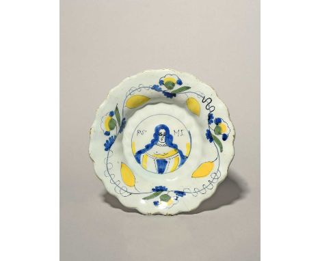 A small Delft lobed portrait dish, c.1685-89, painted in blue, black, green and yellow with the portrait of Princess Mary Stu