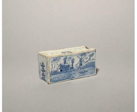 A small Liverpool delftware flower brick, c.1750, the rectangular form painted in blue with a windmill beside other low build