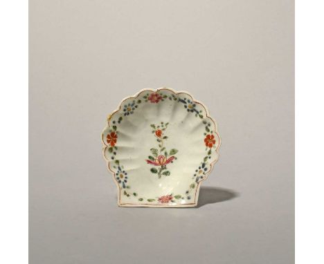 An early Worcester pickle dish, c.1753-54, formed as a scallop shell, painted in polychrome enamels with a central flower spr