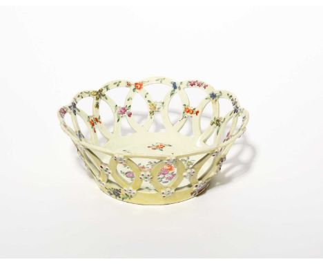 A Worcester yellow-ground basket, c.1765-70, the circular form painted to the interior with colourful flower sprays and small