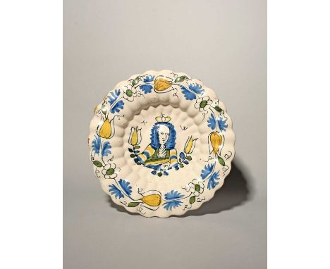A Delft Royal lobed dish or charger, c.1690, moulded with rows of narrow flutes, painted in blue, green, black and yellow wit