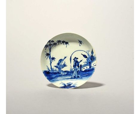 A Vauxhall blue and white saucer, c.1755-58, painted with a heron or other bird perched on a stone plinth beside a Chinese fi