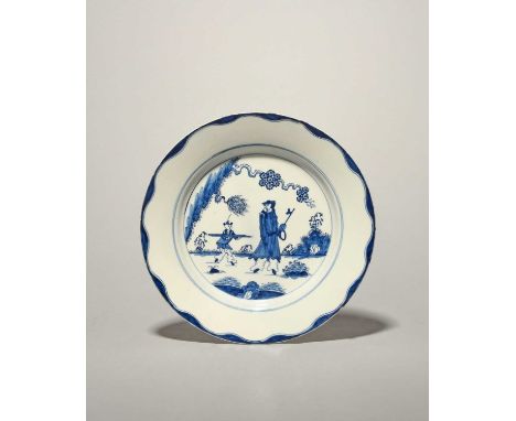 A Bow blue and white plate, c.1758-60, painted with the Golfer and Caddy pattern, a Chinese figure beneath a flowering tree, 