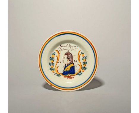 A Delft 'Orangist' portrait plate, c.1790, painted in polychrome enamels with a portrait of Prince William V within a yellow 