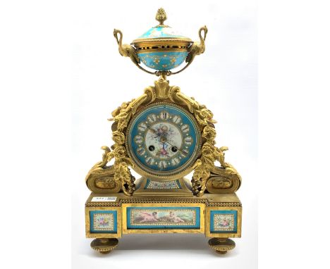 19th century French mantel clock, gilt metal with urn finial over case profusely decorated with a floral composition, enclosi