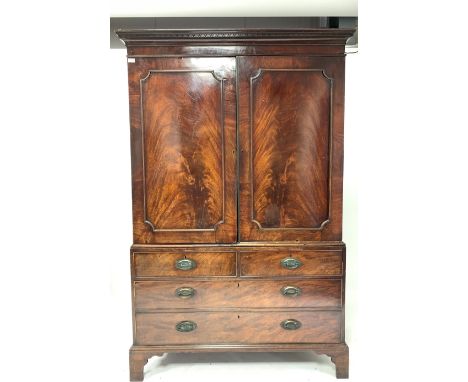 George III mahogany linen press with dentil cornice, the upper section with sliding trays and enclosed by panelled doors, two