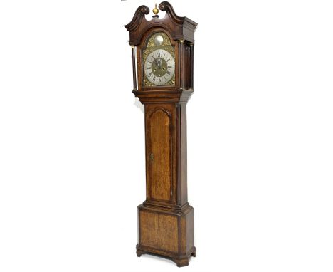 Early 19th century oak long case clock, moulded swan neck pediment with finial above glazed stepped arch hood door, the brass