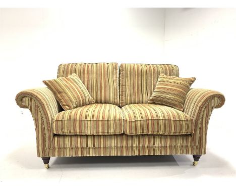 Parker Knoll Burghley two seat sofa upholstered in Baslow Stripe Gold fabric, raised on turned front supports with brass cast