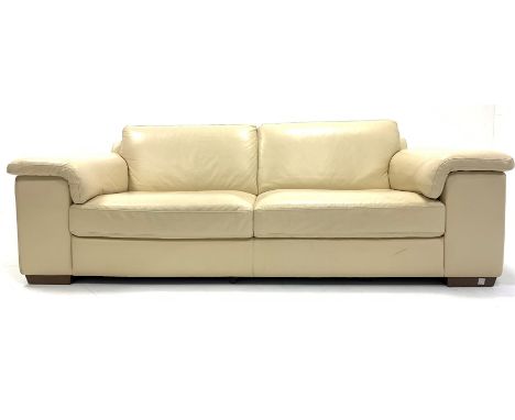 Natuzzi contemporary three seat sofa, upholstered in cream faux leather, raised on walnut block supports, W235cm, H84cm, D102