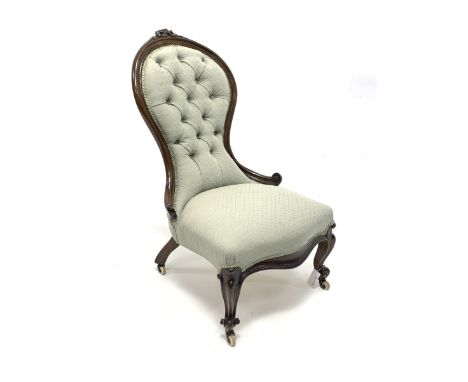 Victorian walnut framed nursing chair, buttoned spoon back with flower head carved cresting rail, cabriole feet with scroll c
