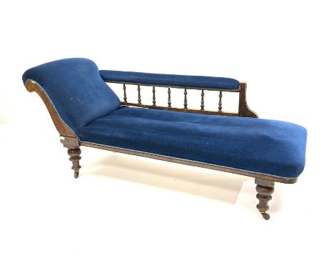 Late Victorian walnut framed chaise longue, with blue velvet upholstery, raised on turned supports and ceramic castors, L178c