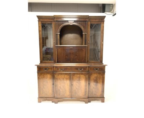 Reproduction mahogany breakfront illuminated cocktail display cabinet, with dentil cornice over glazed doors enclosing adjust