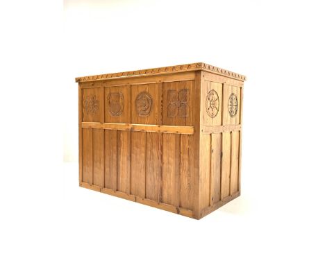 'Catman' pitch pine bar, adzed top over panelled front carved with floral roundels, open shelf, sliding doors and cupboard to