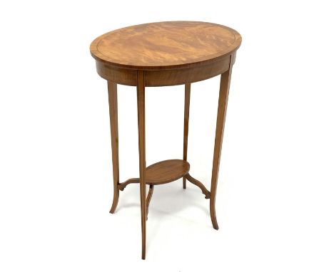 Edwardian satinwood lamp table with oval top, square tapering out splayed supports with ebony stringing joined by undertier, 