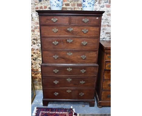 A George III mahogany chest on chest, the two short over six long graduated drawers with brass fittings, raised on shaped bra