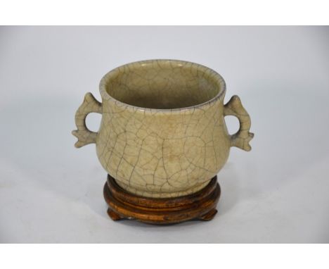A Chinese Ge ware Song style incense burner of archaistic gui-form, the compressed globular body with moulded fish-shaped han