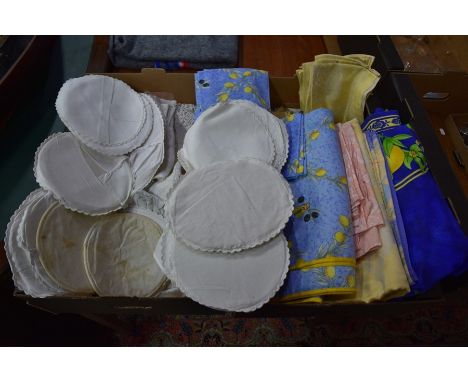 Two boxes of vintage mixed table linens including white crochet-edged table cloths, place mats, coloured and patterned table 