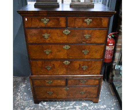 An 18th century feather banded oyster veneered walnut chest on stand with two short over three long graduated drawers, the st