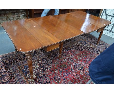 A Georgian mahogany concertina-action extending dining table in the manner of Gillow, with Wilkinson patent action, the doubl