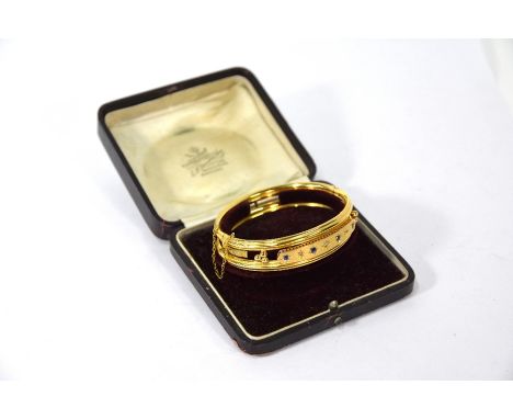 A Victorian sapphire and diamond yellow gold bangle, with wirework surround, hinged opening and with safety chain, 11.4g all 