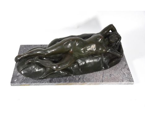 A green patinated bronze reclining female nude, indistinctly signed, on a marble plinth base, 59 cm x 29 cm x 18 cm h o/all