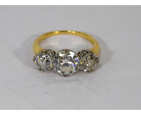 Tiffany & Co - A vintage three stone diamond ring, the central circular claw set diamond approx 1.5 carats with a smaller cir