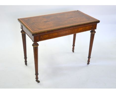 A Louis XVI style ormolu mounted walnut/kingwood card table, the fold over top with baize lined interior, raised on part flut