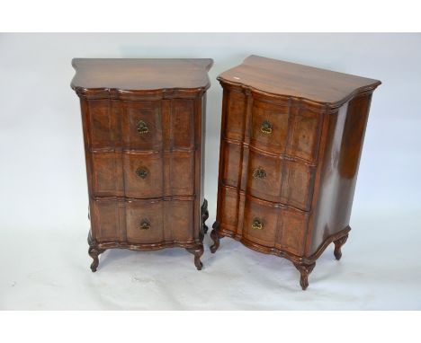 A pair of walnut three drawer chests of serpentine form, raised on short moulded cabriole legs, 60 cm w x 42 cm x 85 cm h (2)