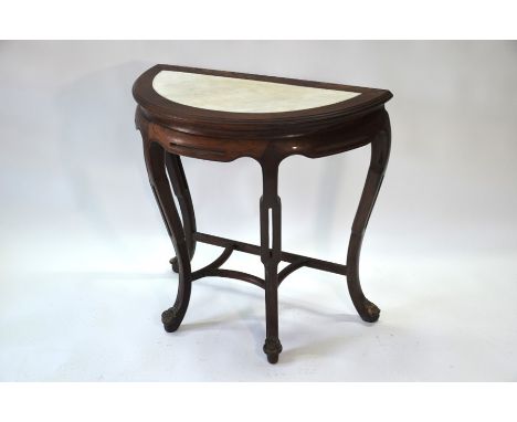 A late 19th or early 20th century Chinese hardwood console table, the moulded demi-lune top with inset white marble panel and