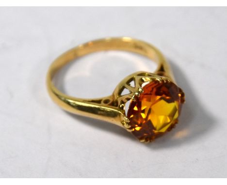 A single stone ring set with circular claw-set orange citrine, yellow metal set stamped 9ct, size MEarly 20th Century; 4g wei