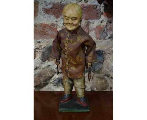 A vintage papier-mache Chinese/Manchu figure on stand, with traditional clothes and carrying opium pipe and pouch, 30 cm high
