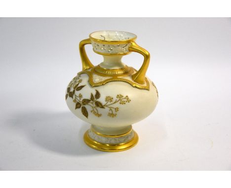 A Victorian Royal Worcester cream-ground vase of compressed baluster form, with twin handles and stemmed foot, decorated with