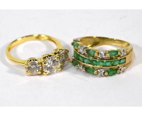 A 9ct yellow gold ring with channel set emeralds and eight moissanite, size K to/w a 15ct yellow gold three stone ring set cu