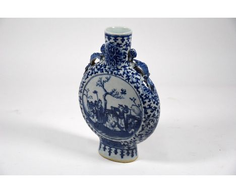 A 19th century Chinese blue and white moonflask with applied chilong handles, painted in underglaze blue with flowering lotus