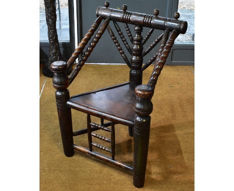 A Victorian oak turners chair with triangular panel seat