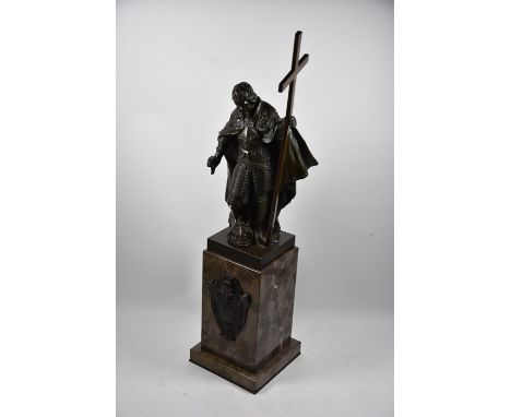 A fine brown bronze sculpture of a knight crusader, holding a crucifixion cross, raised on a substantial marble block base wi