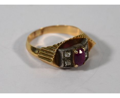 An Odeonesque style ruby and diamond ring, the central oval ruby flanked by two circular diamonds on each side, in boat shape