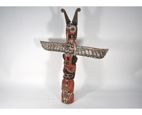 A vintage Canadian Native American totem pole, carved and painted with Raven, Bear and human figures, 88 x 67 cm overall
Note