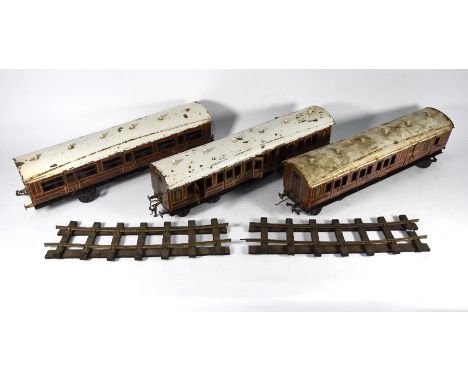 Three vintage Bassett Lowke Bing tinplate gauge 1 First Class carriages in LNER livery, 49 cm long overall, in played-with co