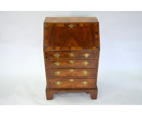 An 18th century style diminutive feather banded walnut bureau, the interior fitted with drawers and niches over a slide top s