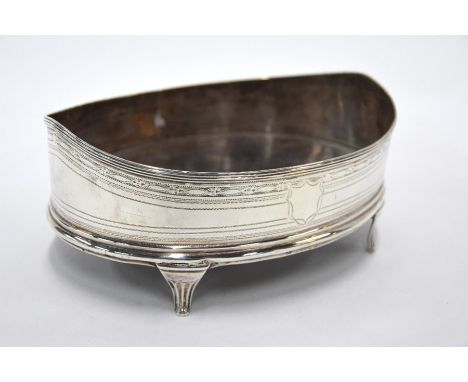 A silver oval bowl of Georgian origin, with raised ends, bracket feet and wrigglework decoration, mahogany inset base, marks 