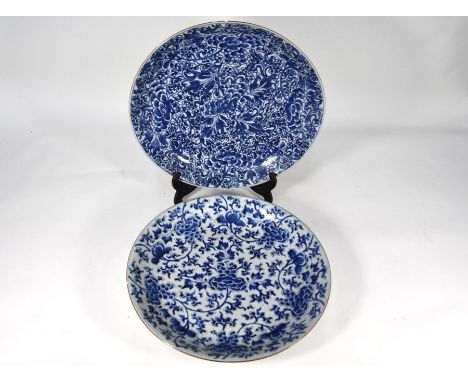 A Chinese blue and white charger, Kangxi period (1662-1722) painted with a floral and foliate design in underglaze blue, the 